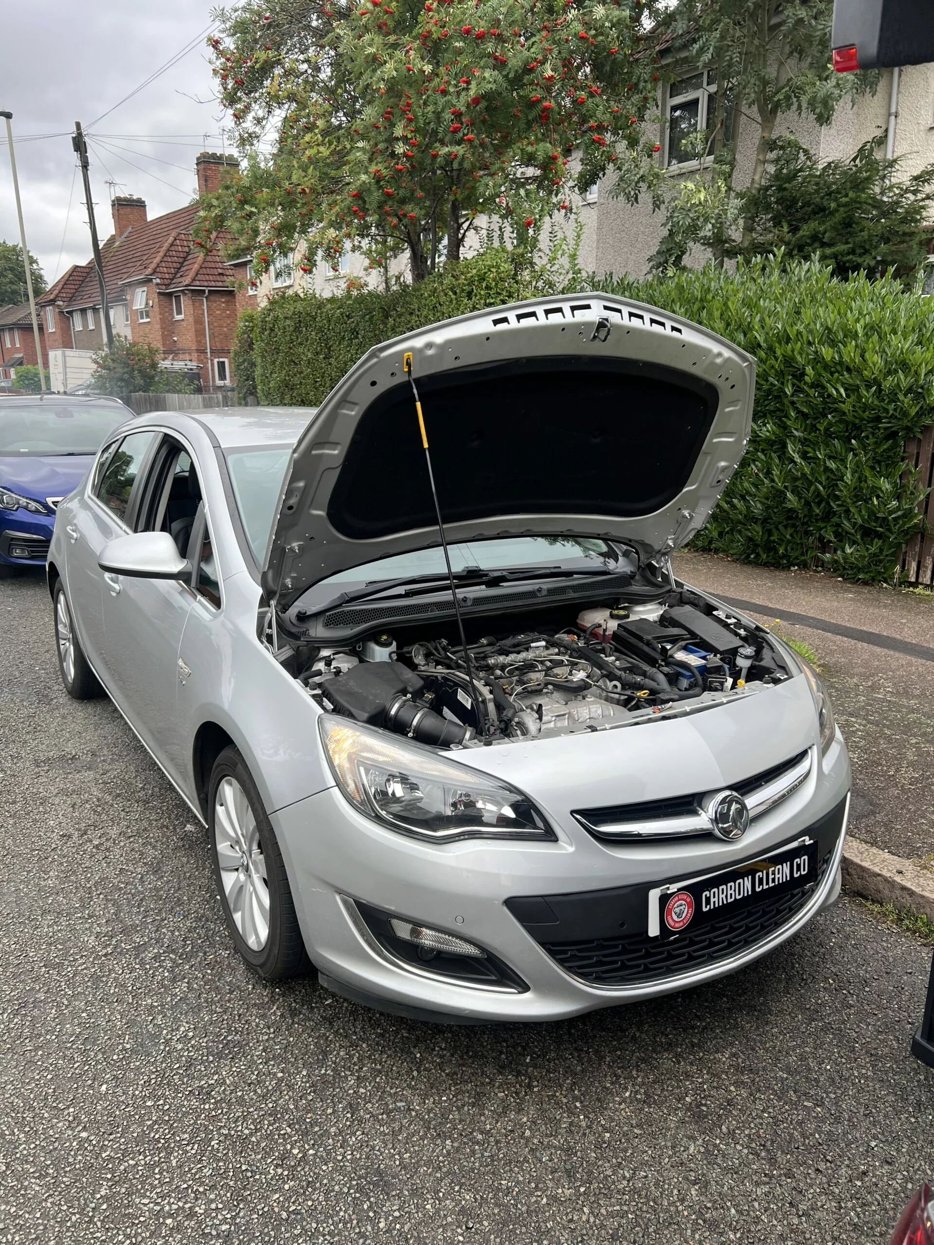 Customer Vauxhall with bonnet open during a mobile service appointment